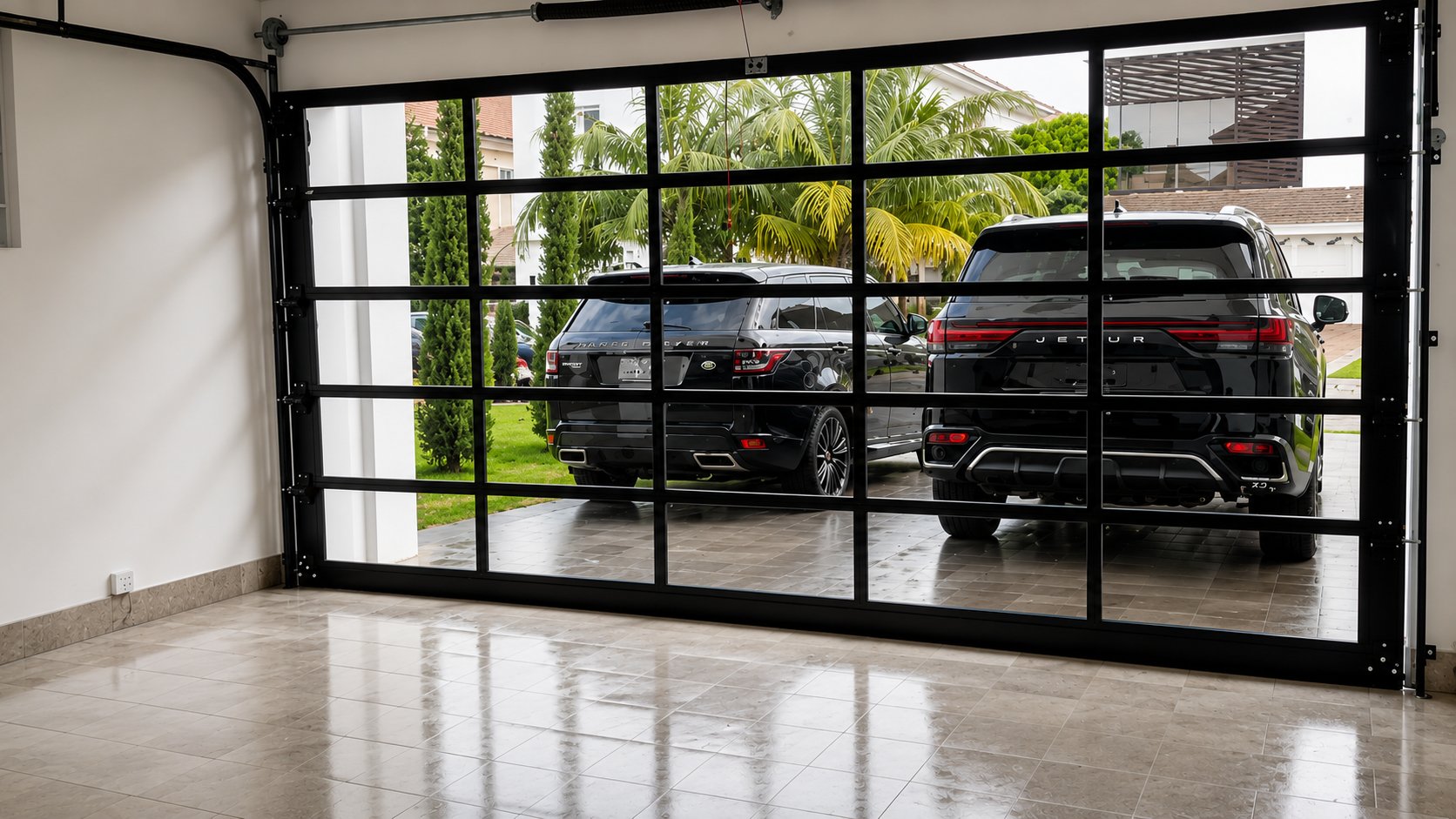 Motorised glass-panel garage door with cars visible through it